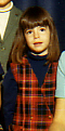 Krista in kindergarden wearing a red plaid jumper